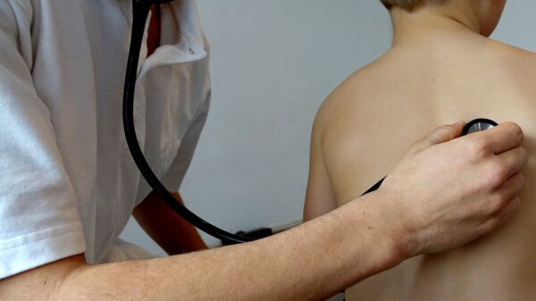 doctor checks patient's breathing using a stethoscope