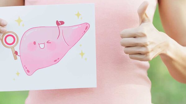 woman doing thumbs up and holding a paper with pink liver drawing