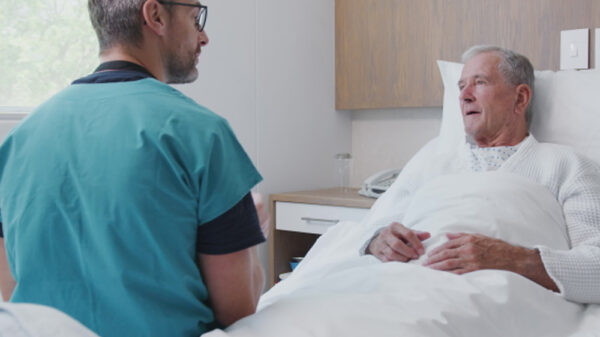 patient on the bed talking to the physician